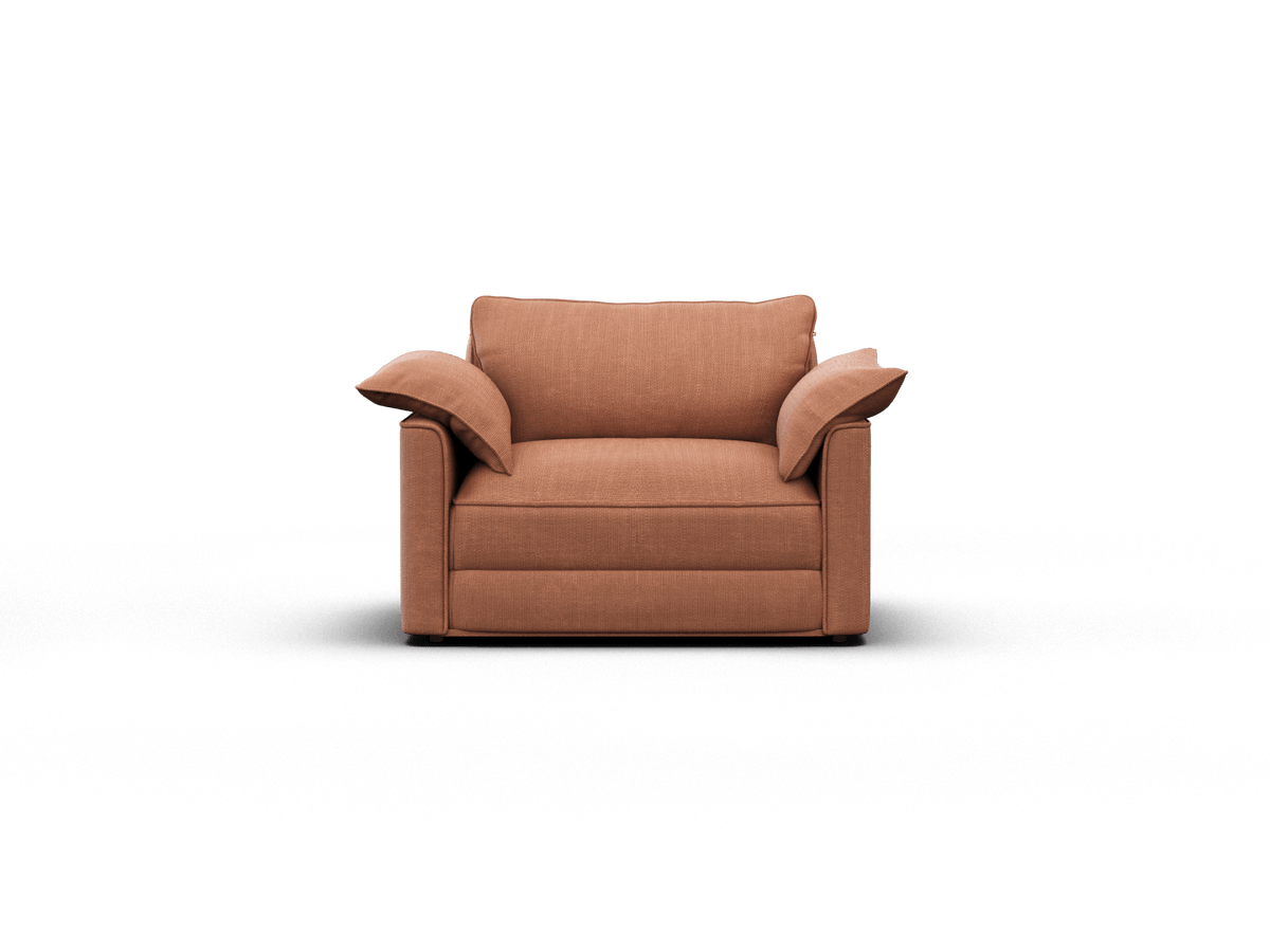 Plush armchair in warm terracotta fabric with wide armrests, deep cushions, and clean lines; perfect for a sophisticated living room ambience.
