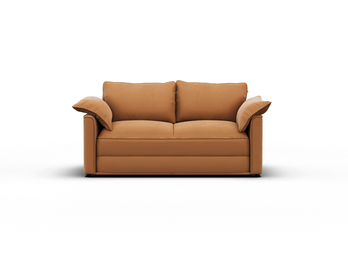 Modern two-seater sofa in rich caramel leather with plush cushions and sleek lines, set in a minimalist living space.