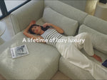 Woman lying on a grey couch