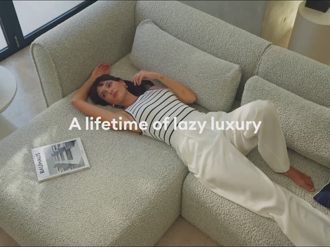 Woman lying on a grey couch