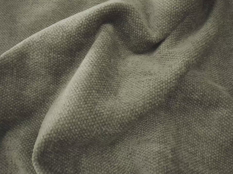 an olive green fabric shown scrunched up to highlight fabric comfort in close up and person spilling water on fabric to highlight its easy cleaning feature