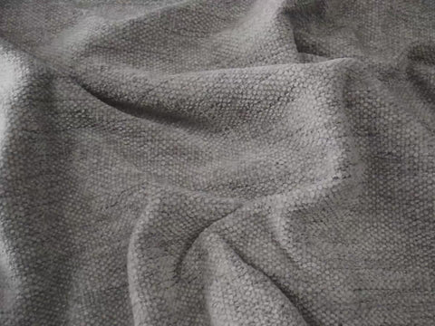 close up of light gray fabric in sunny room