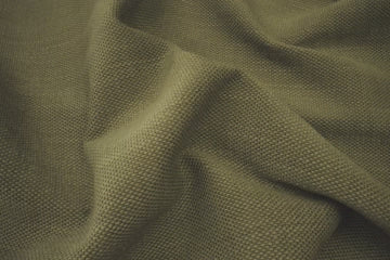 a beautiful olive green fabric showing its texture