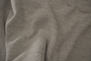light gray fabric close up to see texture and water spilling with easy clean up to highlight fabrics durability