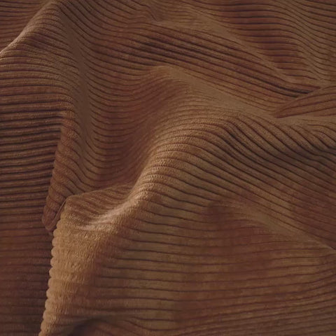 close up of tan corduroy fabric in sunny room